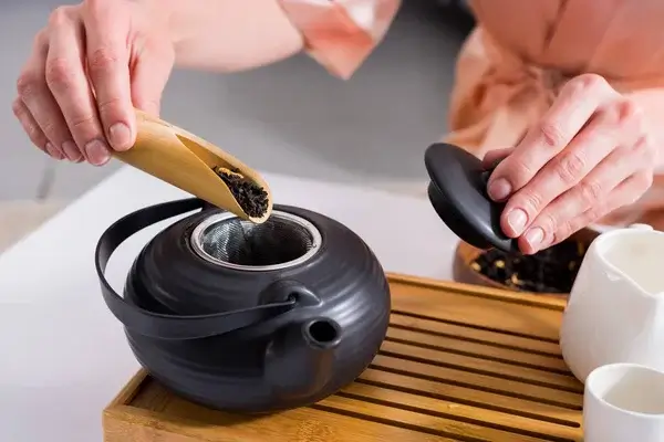cropped-shot-woman-making-tea
