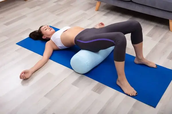 woman practicing yoga bolster 1